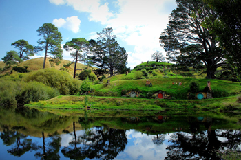 Hobbit holes reflected in water.